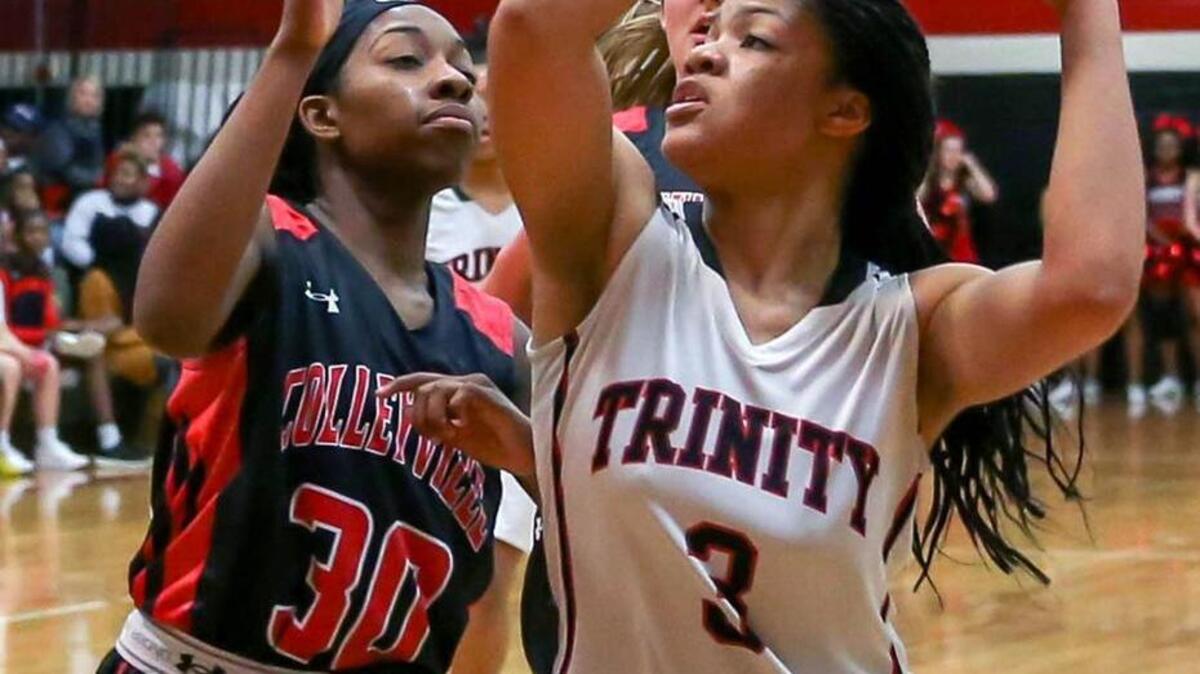 Euless Trinity guard Trinity Oliver, right, led area girls scoring. Here she goes up for a shot against Colleyville Heritage forward Angel Guyton, January 26, 2016 at Trinity High School.