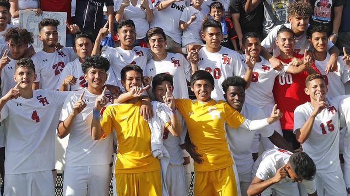 Arlington Sam Houston soccer players celebrate with fans during the 2017 UIL playoffs.