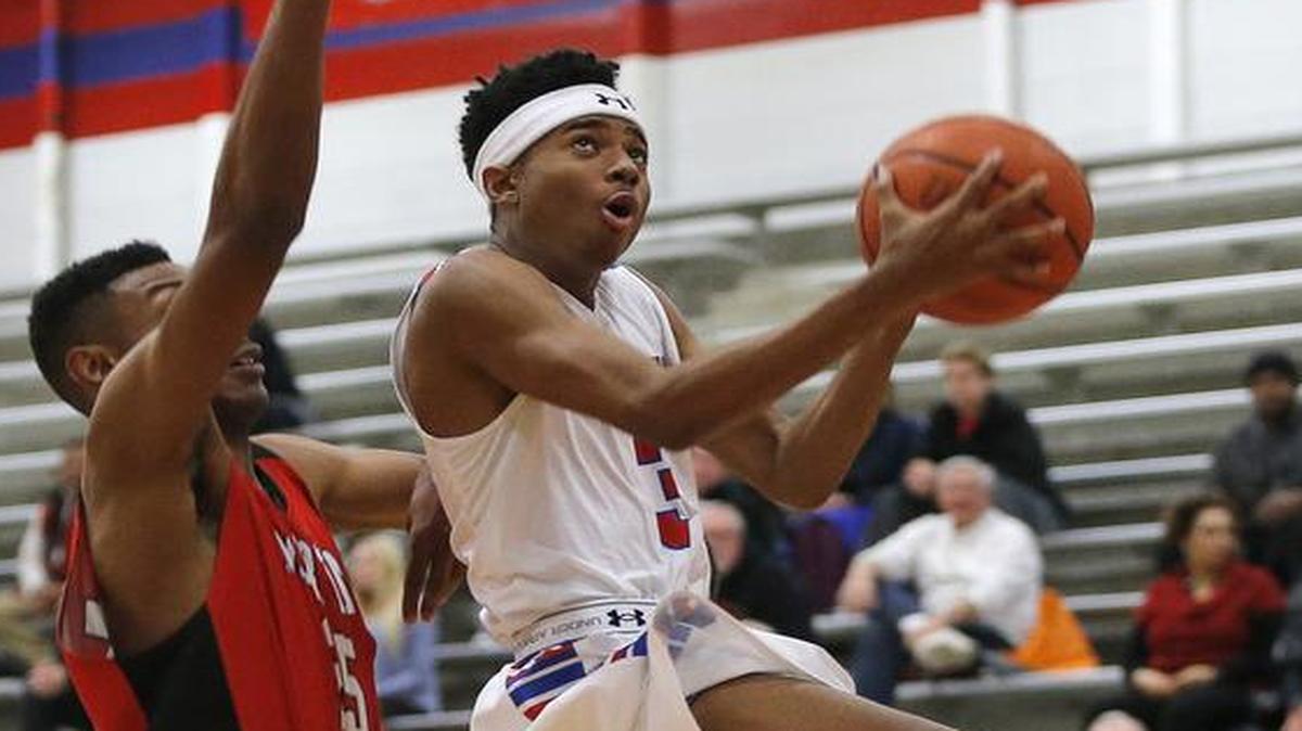 OT Hodge of Arlington Sam Houston drives to the basket in the first half of Tuesday’s game against Arlington Martin.