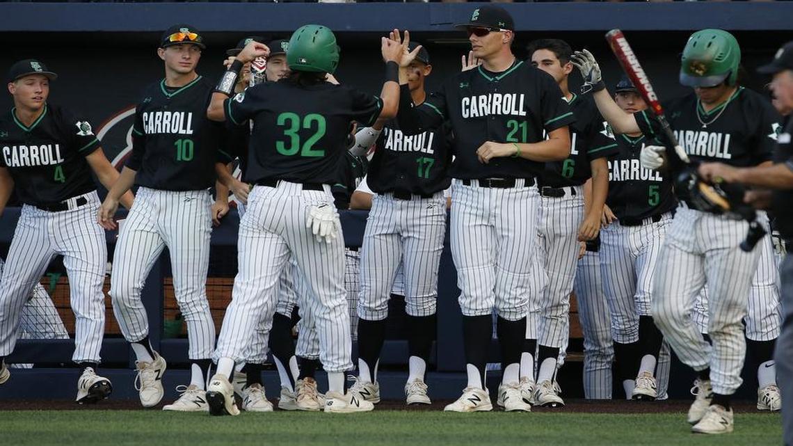 Southlake Carroll first baseman Nik Millsap (32) is congratulated after scoring a run in the top of the fifth inning against Arlington Martin in the baseball playoffs at Dallas Baptist University, June 1, 2017.
