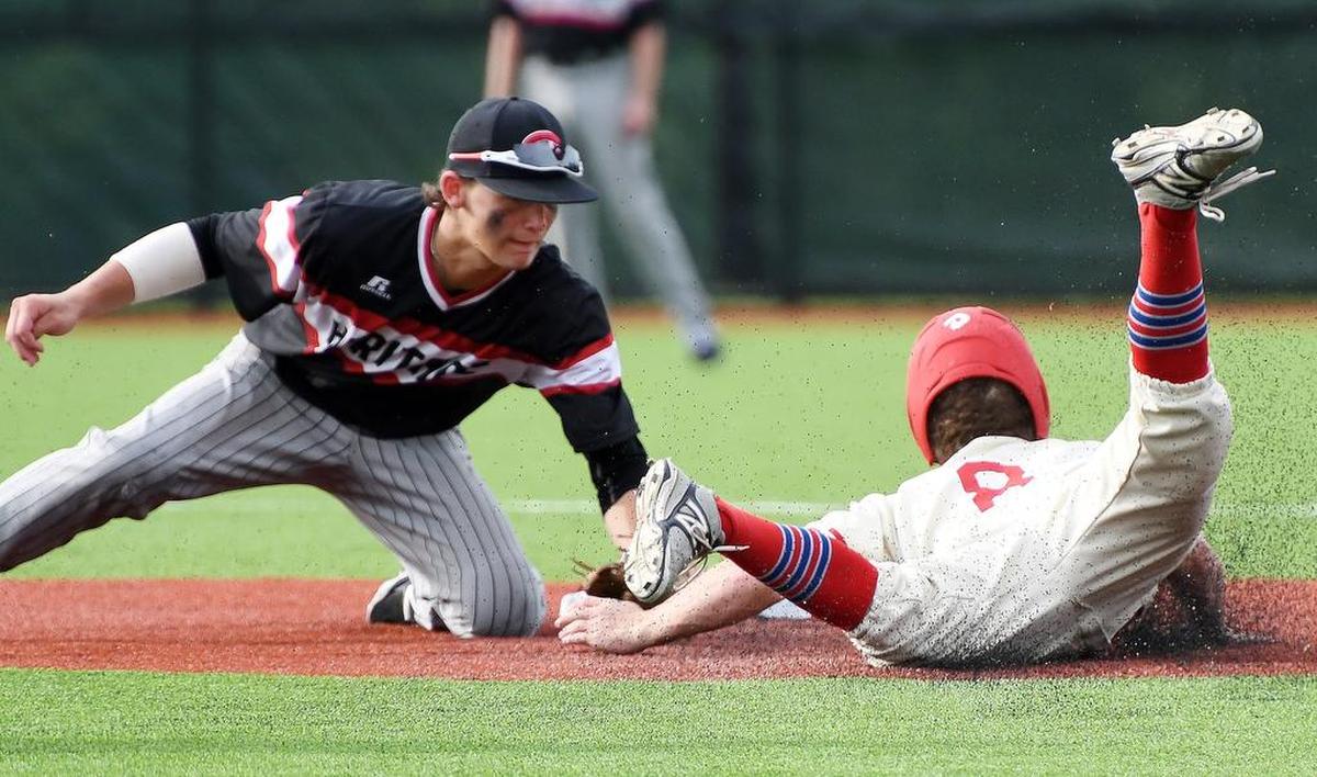 Colleyville Heritage’s Bobby Witt, left, tags out Grapevine’s Andrew Gootos during a high school playoff game in Texas.