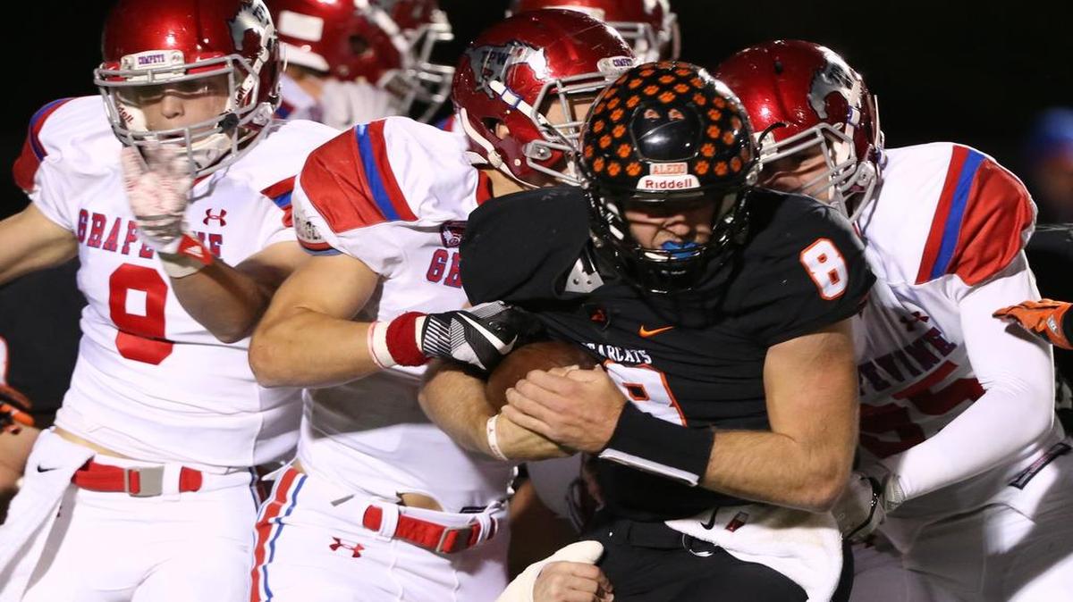 A host of Grapevine defenders swarm an Aledo ball carrier last season. With all linemen and linebackers having graduated since then, rebuilding the front has been a project for new head coach Mike Alexander.