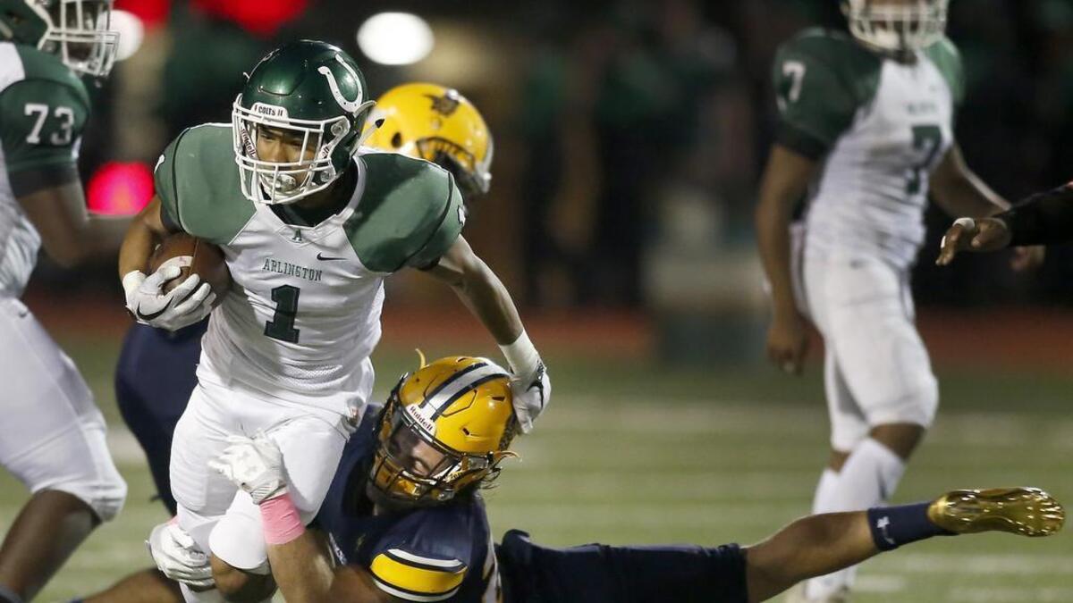 Arlington Colts running back Darien Ruffin (1) is tackled by Arlington Lamar Vikings Cade Tresch (20) in the first half of a high school football game at Cravens Field in Arlington, Texas on Friday.