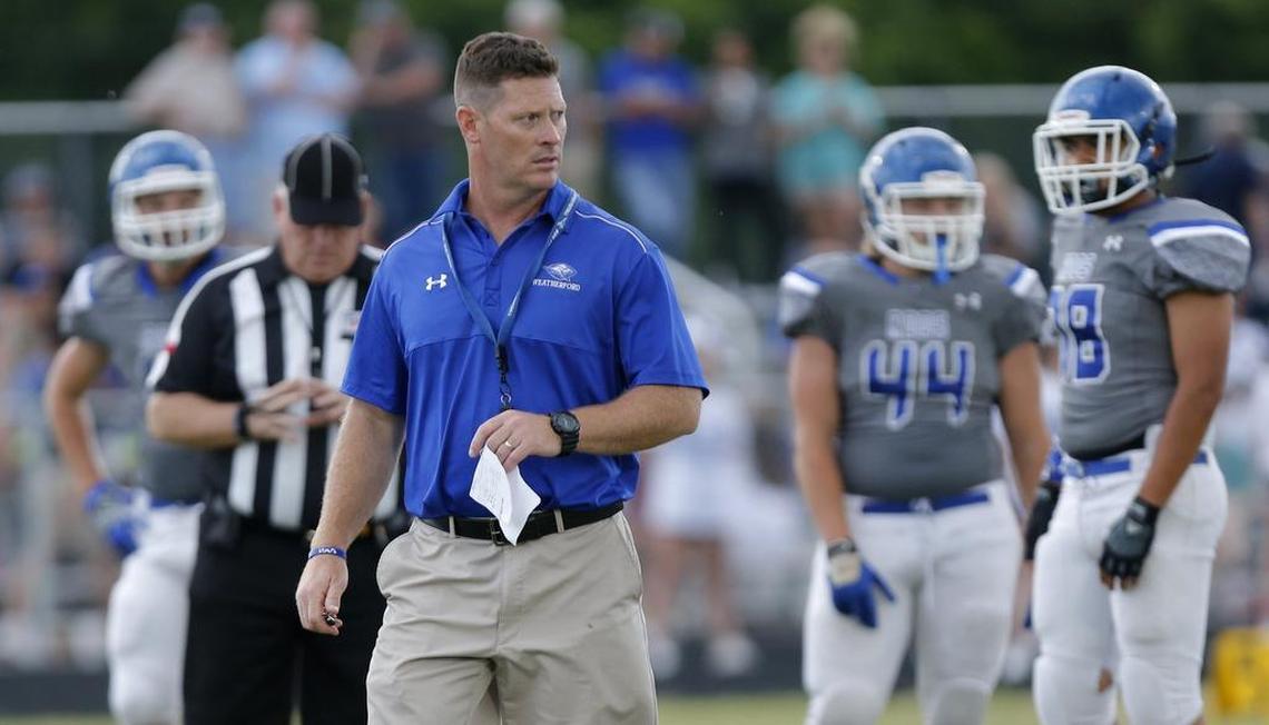 Head coach Billy Mathis works with his players during the Weatherford spring football game on May 22.