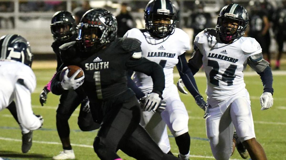 South Hills quarterback Trey Jones, left, races to the end zone past YMLA's Deuntae Hartin and J'eon Burnett.