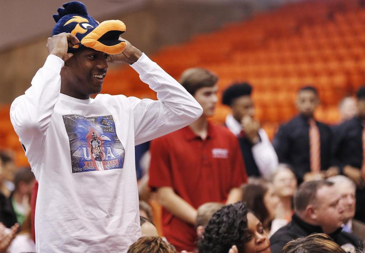 Tariq Woolen of Arlington Heights adjusts his UT San Antonio Roadrunners hat during Fort Worth ISD’s signing day ceremony at Wilkerson-Greines Activity Center.