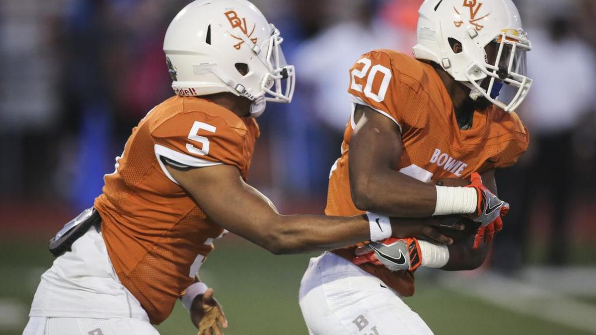 Bowie quarterback Donoven Davenport hands the ball off to Branden Ellis.