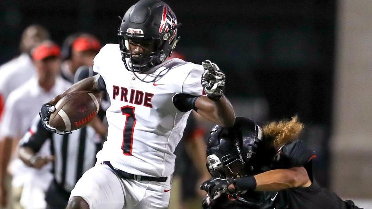 Colleyville Heritage wide receiver Ke’Von Ahmad (1) races down the sideline against Trinity defensive back Sebastian Tauaalo (32), Sept. 15, 2017.