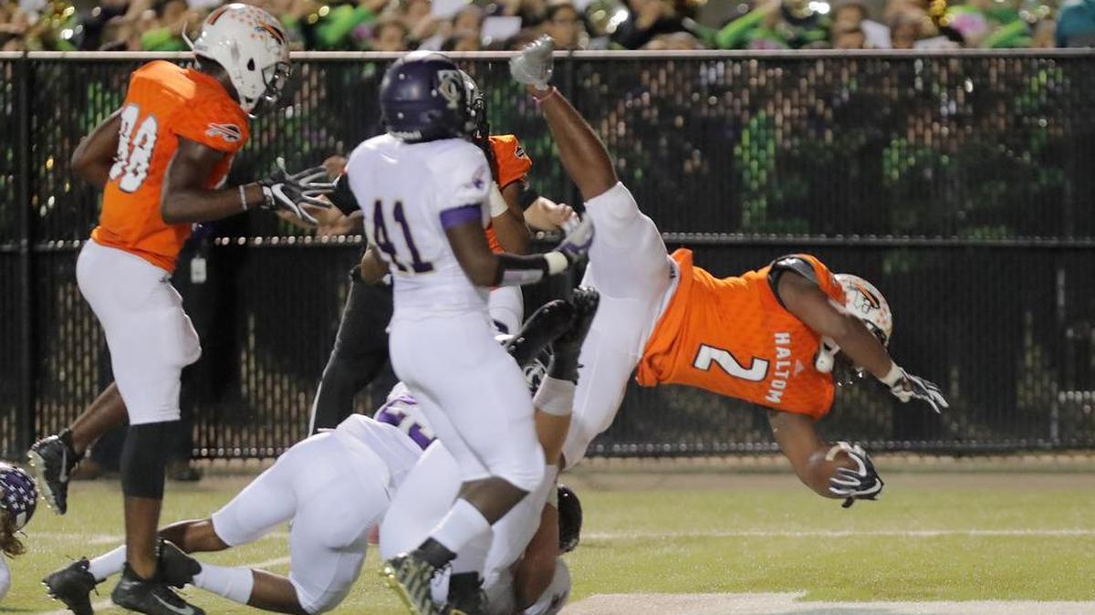 Haltom running back Zacc Smith dives for a touchdown against Timber Creek .