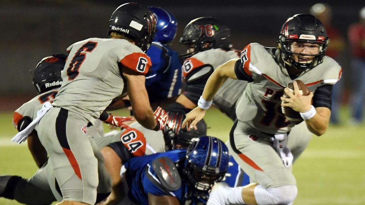 Colleyville Heritage quarterback Cam Roane, right, scrambles against Fort Worth Dunbar, Sept. 23, 2016.