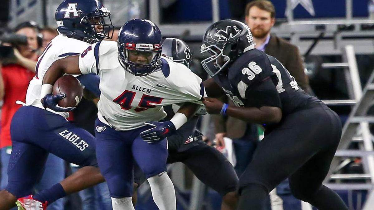 Allen running back Kirby Bennett, left, is dragged down by Arlington Martin’s Myles Kelley during a playoff game in November at AT&T Stadium. Bennett transferred to Las Vegas (Nev.) Bishop Gorman from Allen in January but was dismissed by Gorman in June. He is now enrolled at Frisco Lone Star.