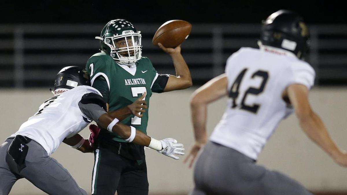 Arlington Colts quarterback D'montae Davis (7) is hit by Mansfield Tigers Kason McCullough-Cooper (7) on Oct. 6.