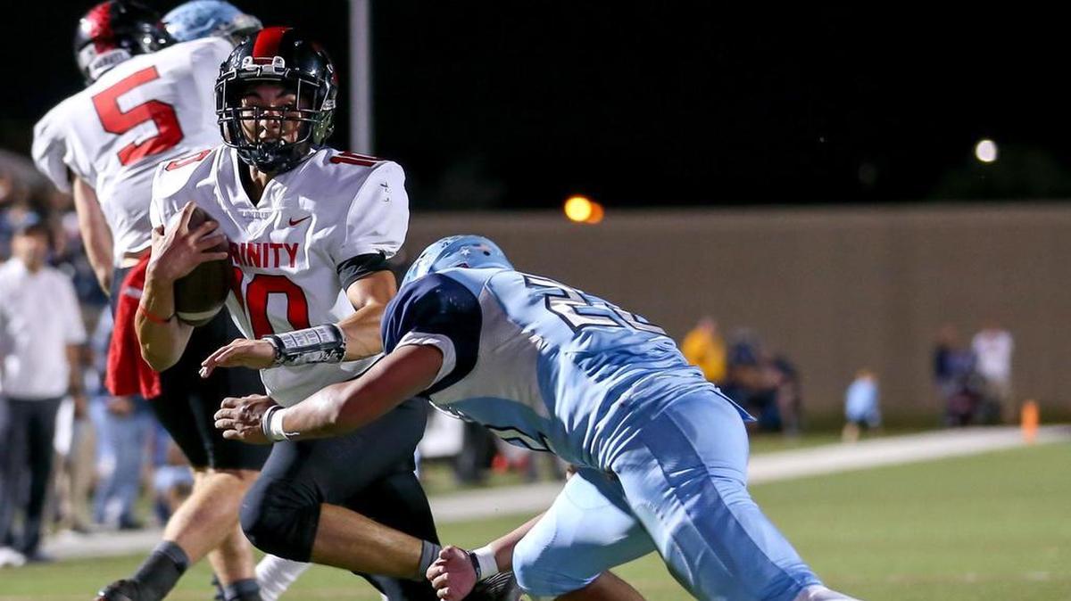 Trinity quarterback Esteban Larranaga (10) tries to get around L.D.Bell defensive back Michael Saavedra (22) in October. He’s up for an academic scholarship.