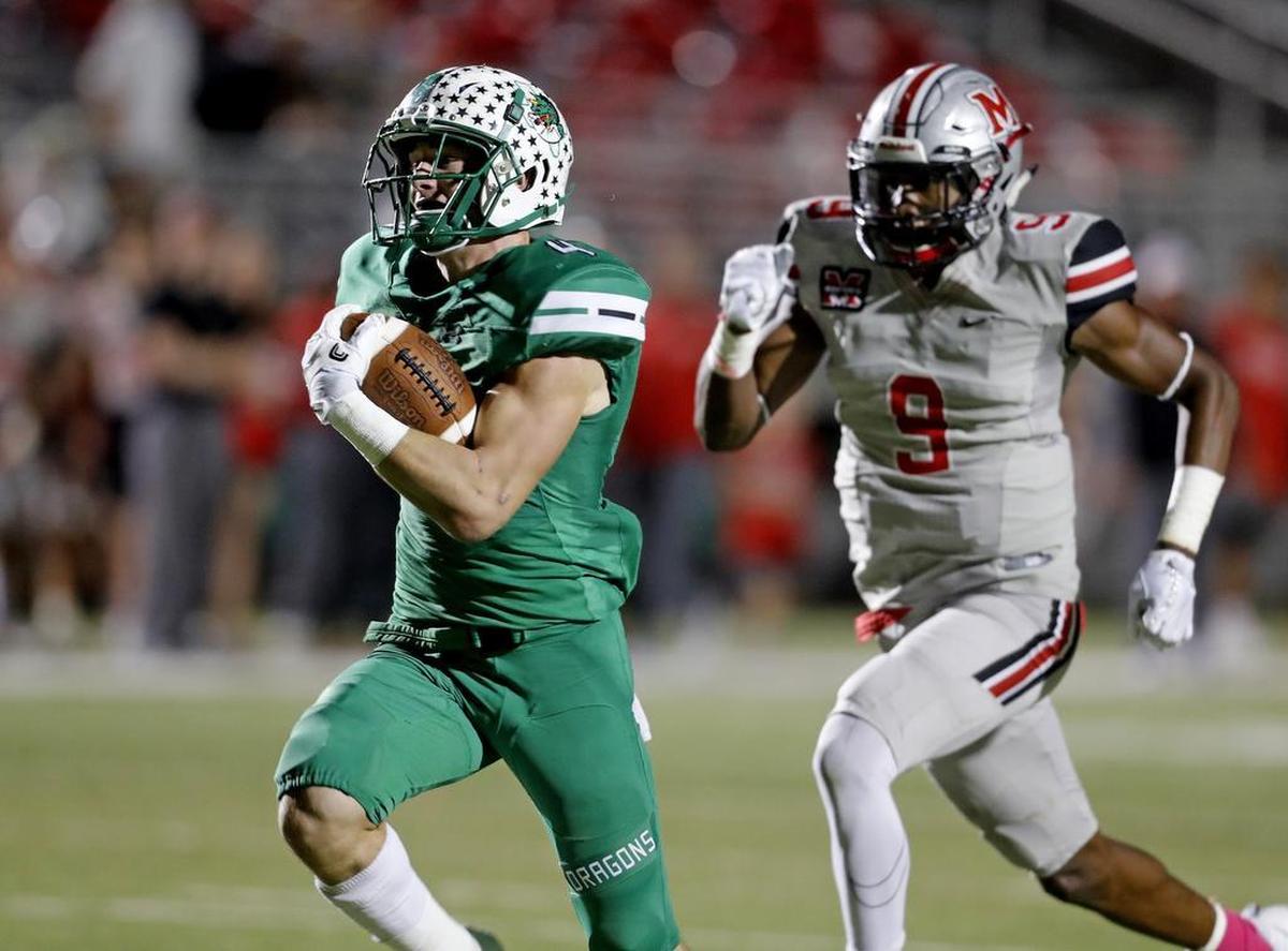 T.J. McDaniel is chased by Marcus linebacker Marcel Brooks (9) to the end zone for a touchdown as Marcus played Carroll in high school football at Dragon Stadium in October.