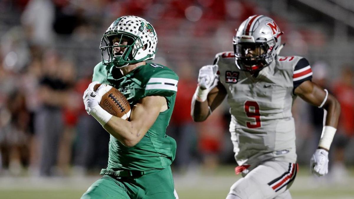 T.J. McDaniel is chased by Marcus linebacker Marcel Brooks (9) to the end zone for a touchdown as Marcus played Carroll in high school football at Dragon Stadium in October.
