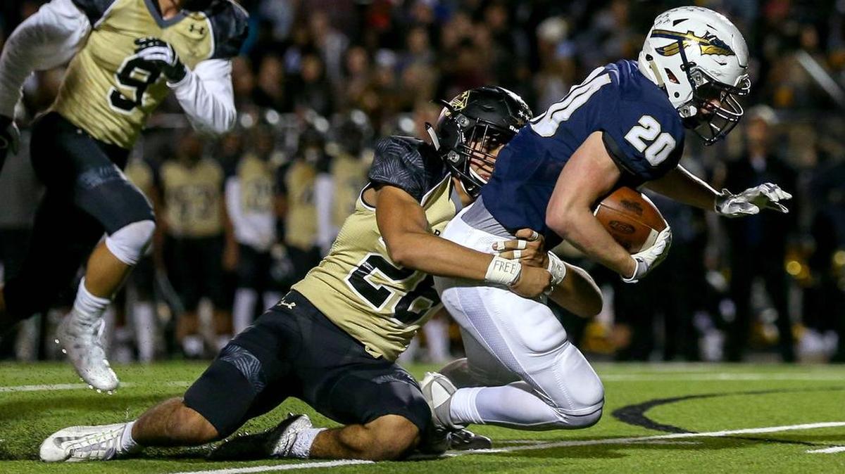 Keller running back Devon Collins (20) is dragged down by Fossil Ridge linebacker Marco Olivas (26).