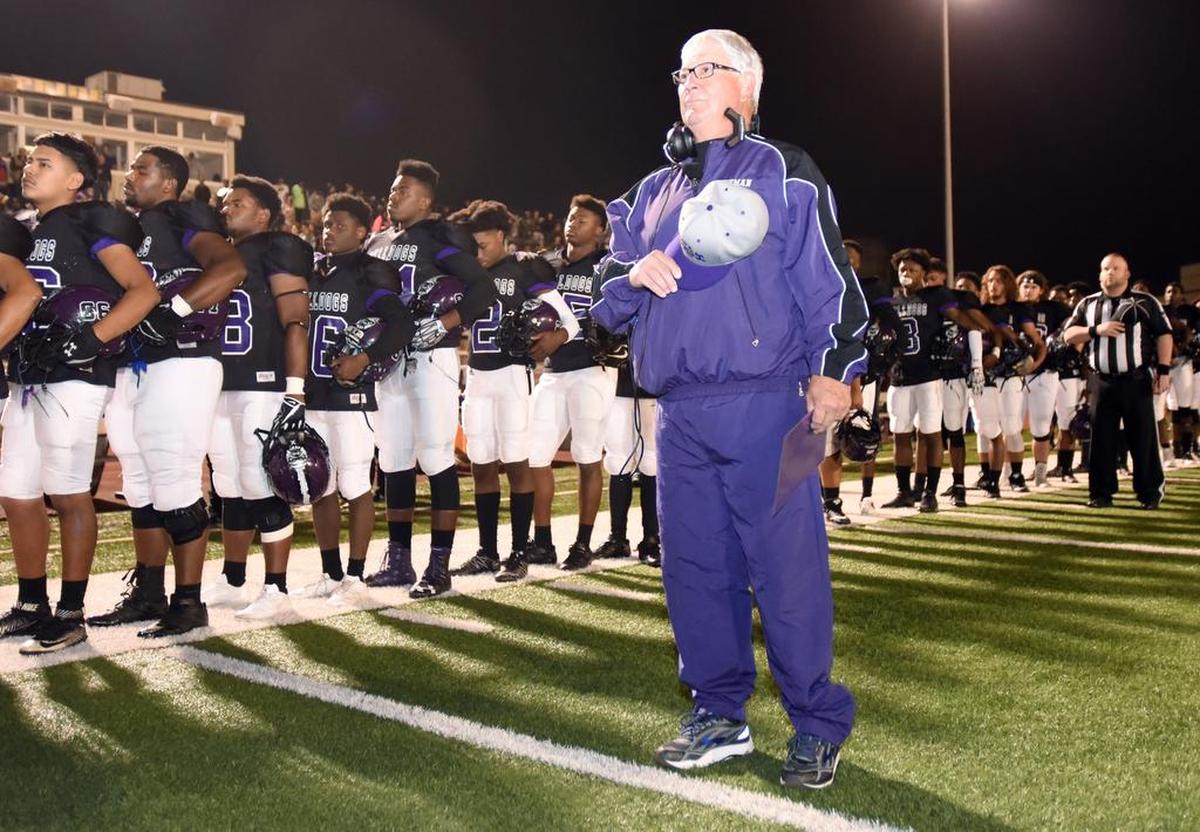 Everman Coach Dale Keeling during the national anthem with his team before taking on Crowley.