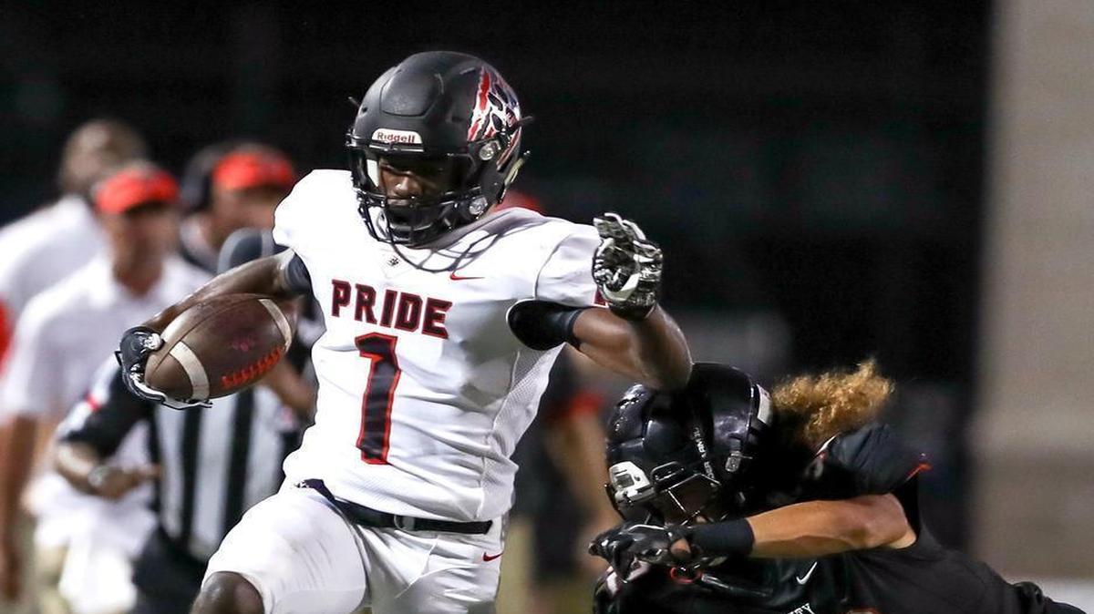 Colleyville Heritage wide receiver Ke'von Ahmad (1) scoots down the sideline against Trinity defensive back Sebastian Tauaalo (32) during the first half Friday night, September 15, 2017 at Pennington Field in Bedford.