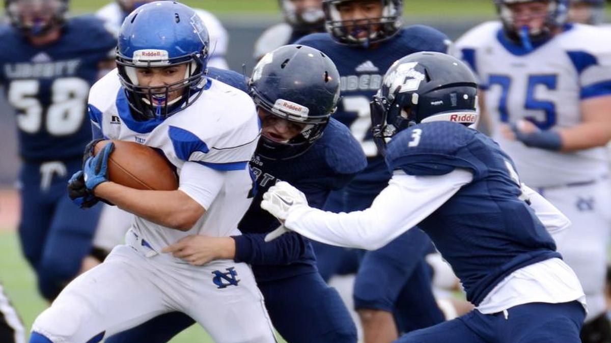 Nolan Catholic’s Rory Mitchell, left, races for a first down with Argyle Liberty’s Sam Bergstrom and Elijah Edwards in pursuit during the third quarter of last year’s playoff game.