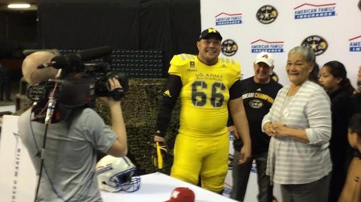 Facing from left, Aledo’s Chuck Filiaga, Aledo coach Steve Wood and Filiaga’s grandmother Edith McCoy celebrate the offensive lineman’s choice of Michigan at the 2017 U.S Army All-American Bowl.