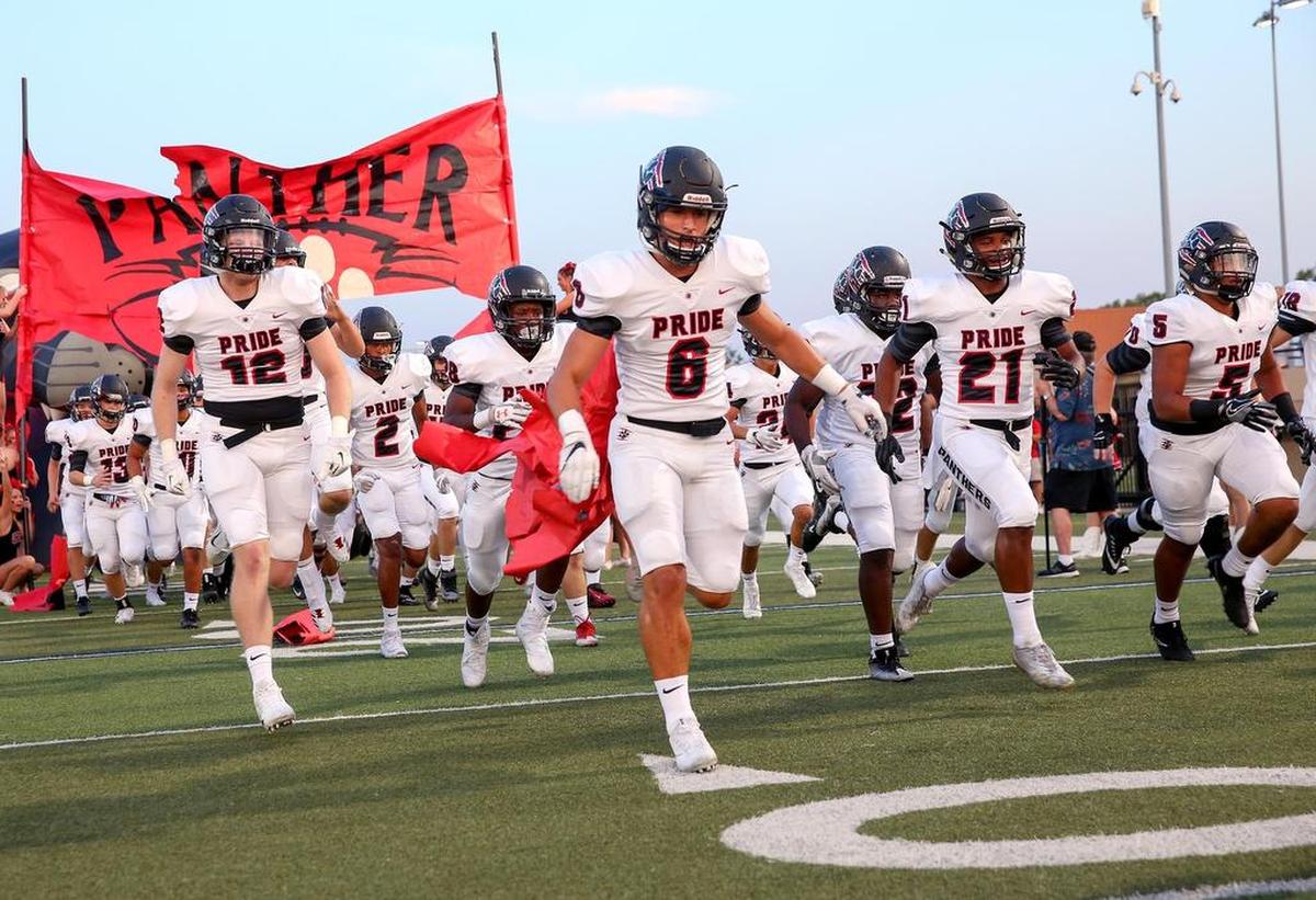 Colleyville Heritage enters the field to play the Trinity Trojans at Pennington Field, Sept. 15, 2017.