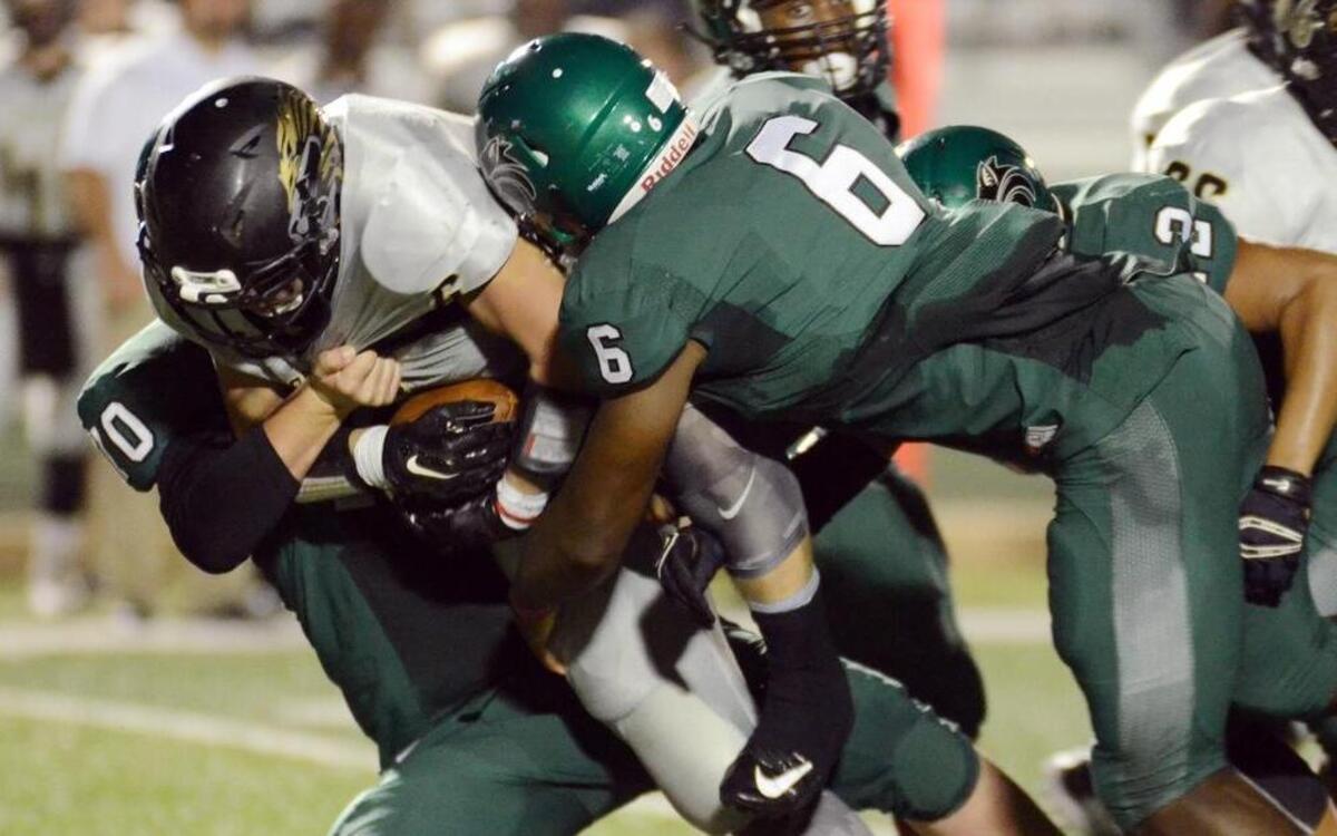 Kennedale's Baron Browning (6) wraps up Kaufman's Devyn Morris for a loss during the second quarter of Friday's September 18, 2015 football game at Wildcat Stadium in Kennedale.