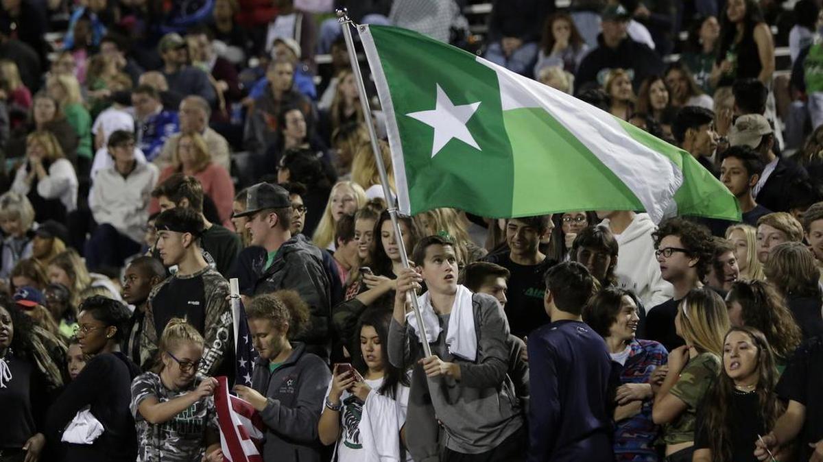 In a Week 10 game, Arlington Colts fans cheer their team against the Arlington Martin.