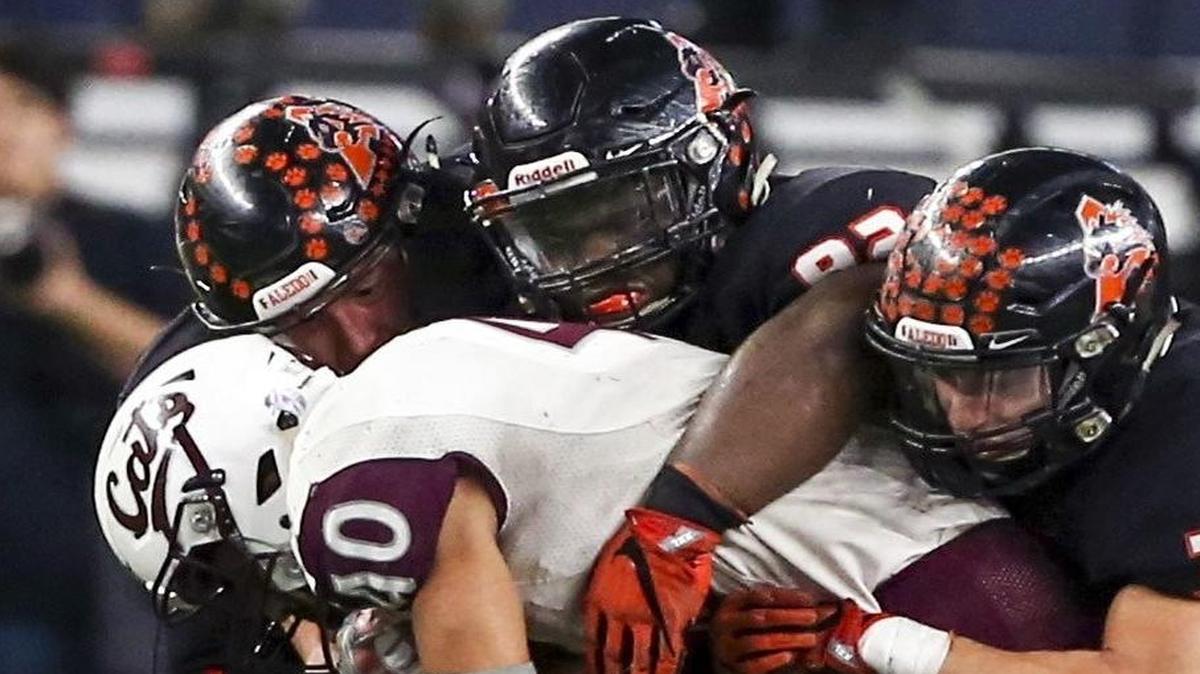Aledo’s Wyatt Harris (L), James Williams (Middle) and Michael Arlt (R) smother the run by Calallen’s Alec Brown in the 5A Division II State Championship Game at AT&T Stadium, Friday, December 16, 2016.