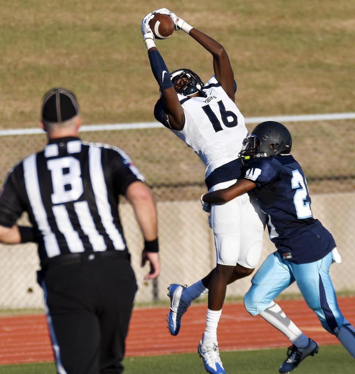 Arlington Heights receiver Tariq Woolen brings down a catch in the corner of the end zone against the coverage of Fort Worth Wyatt’s Corjuan Cooper to take a 28-0 lead in the fourth quarter.