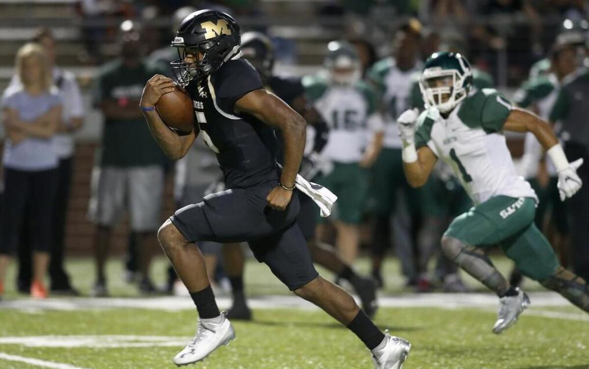 Mansfield Tigers running back Kennedy Brooks (5) blows through the Arlington Colts defense for his first touchdown in the first half of a high school football game at Newsom Stadium in Mansfield, Texas on Friday, Sept. 30, 2016.