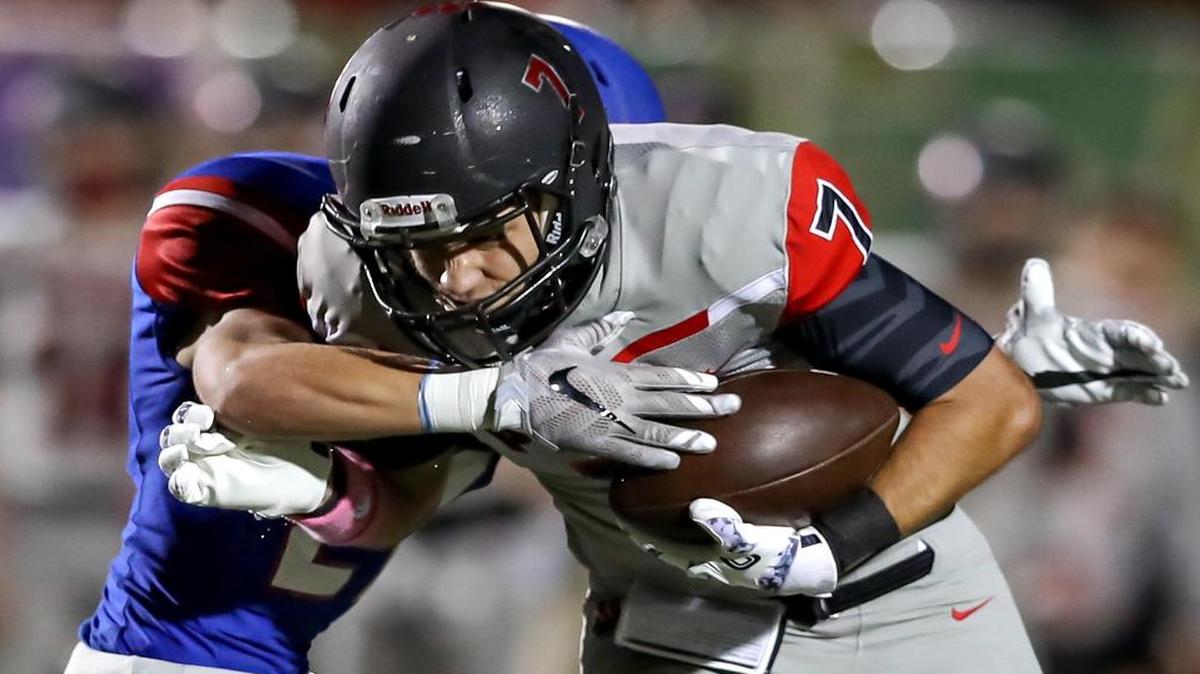 Colleyville Heritage receiver Jared Webster (7) fights for yardage against Grapevine DB Cameron Hamway, Oct. 21, 2016. Hamway recorded two interceptions in the game.