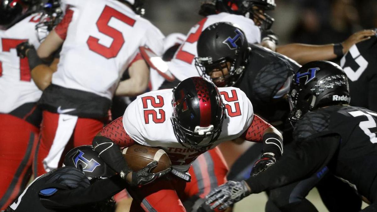 Trinity running back Simeon Ellsworth (22) gained hard yardage up the middle all game as Euless Trinity played Hebron.