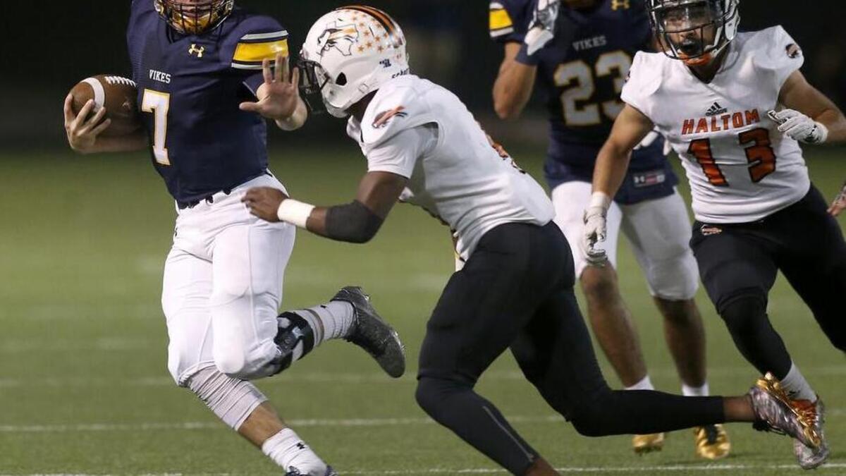 Arlington Lamar Vikings quarterback Jack Dawson (7) rushes against Haltom Buffalos safety Keyon Shannon (4) in the first half of a high school playoff football game at the Gopher-Warrior Bowl in Grand Prairie, Texas on Thursday Nov. 16, 2017.