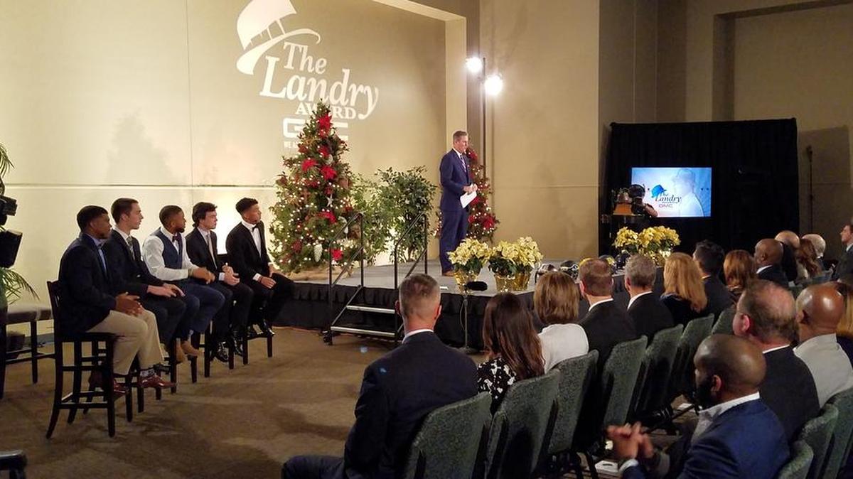 CBS reporter Bill Jones with the finalist for the Landry Award at the Hope Center in Plano, December 11, 2017.