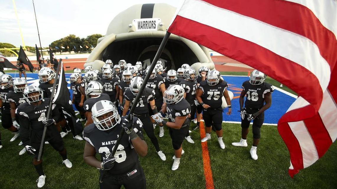 Arlington Martin Warriors defensive lineman Myles Kelley (36) prepares to lead the team onto the field against Dallas Skyline in a Class 6A high school football game at Maverick Stadium in Arlington, Texas on Friday, Aug. 26, 2016.