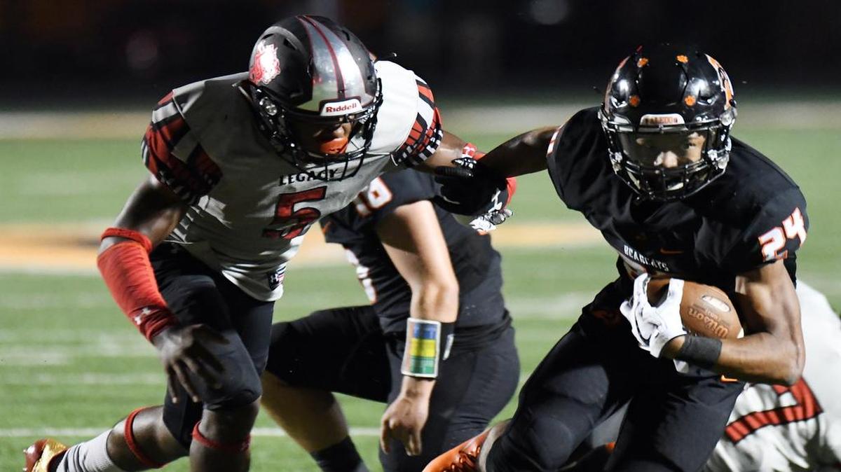 Mansfield Legacy's Jalen Catalon, left, drags down Aledo's Jason Kerl.