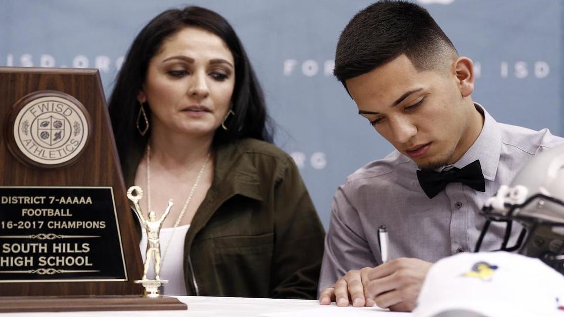 Adriana Albarran, left, looks on as her son Sergio, a South Hill High School senior, participates in Fort Worth ISD's signing day ceremony at the Wilkerson-Greines Activity Center in Fort Worth, Wednesday, February 1, 2017.