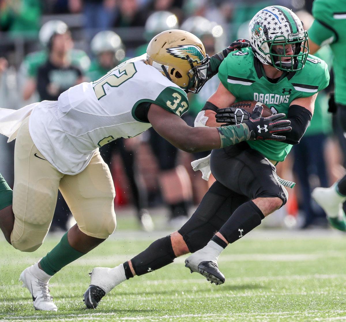 Southlake Carroll running back TJ McDaniel (4) tries to fight off a tackle from DeSoto linebacker Shemar Turner (32) during the first half, Saturday afternoon, November 24, 2018 in the 6A Division I Area playoff game played at Newsom Stadium in Mansfield, TX.
