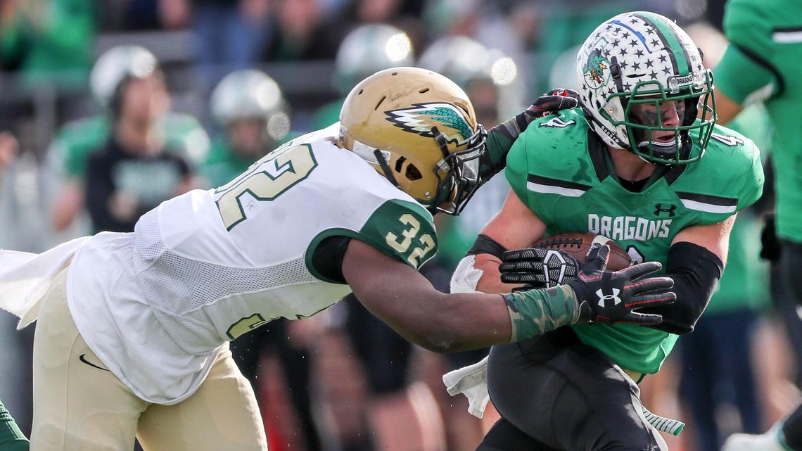 Southlake Carroll running back TJ McDaniel (4) tries to fight off a tackle from DeSoto linebacker Shemar Turner (32) during the first half, Saturday afternoon, November 24, 2018 in the 6A Division I Area playoff game played at Newsom Stadium in Mansfield, TX.