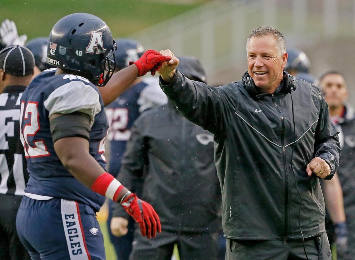 Allen’s Jayden Jernigan (42) is congratulated by head coach Terry Gambill during the second half of Saturday’s game against Round Rock Cedar Ridge.