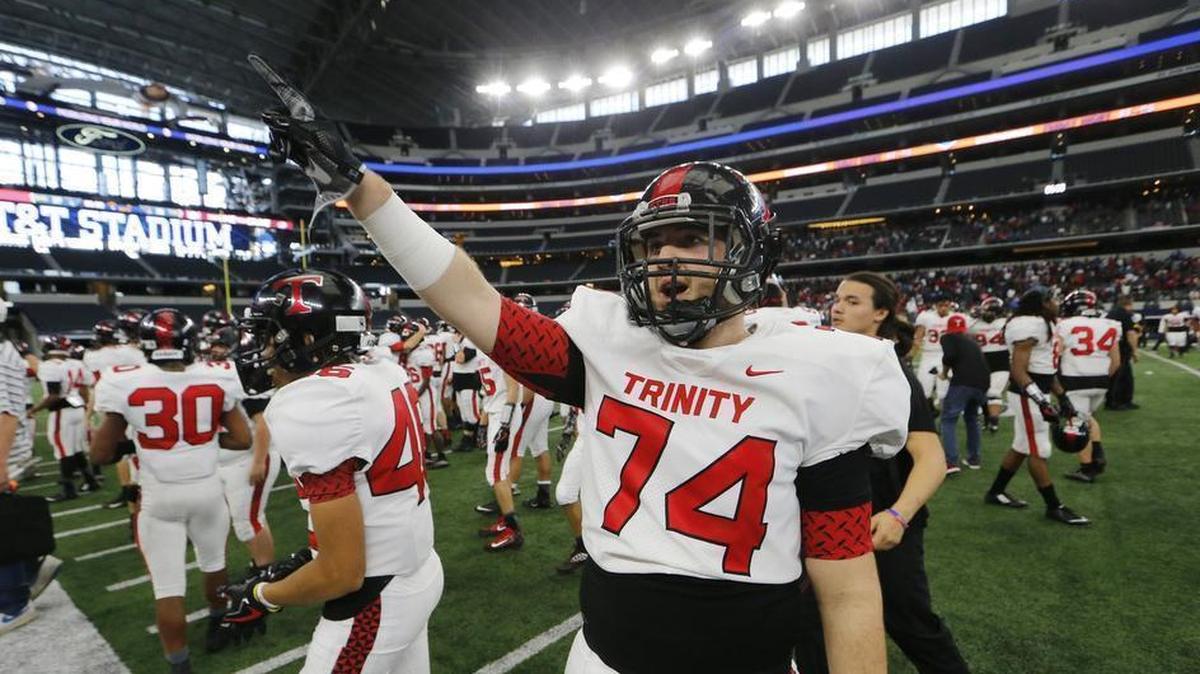 Euless Trinity players celebrate the Trojans 28-27 playoff win against Duncanville..