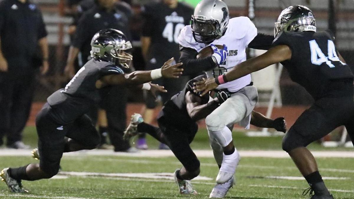 Darrell Williams of Burleson Centennial runs into the heart of the Arlington Seguin defense on Thursday.