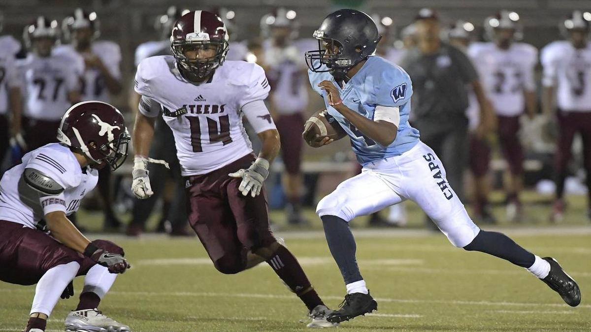 North Side defenders Juan Salgado (33) and Joesph Franco (14) converge on Wyatt quarterback Michael Franklin (4), Sept. 28, 2017.