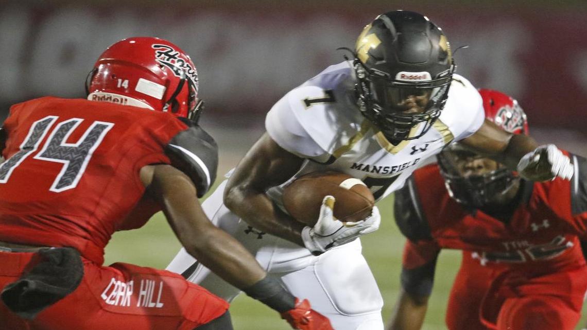 Mansfield wide receiver Saiid Adebo (7) cuts back in front of Cedar Hill strong safety Josh Newman (14) at Longhorn Stadium Friday night Sept. 02, 2016.