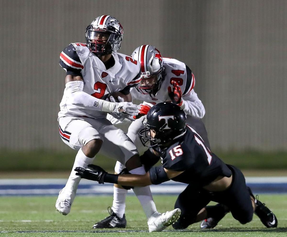 Flower Mound Marcus RB Justin Dinka (2) tries to elude Trintiy DB Sampson Tasini (15) during the 1st quarter, Thursday night, November 3, 2016 played at Pennington Field in Bedford.