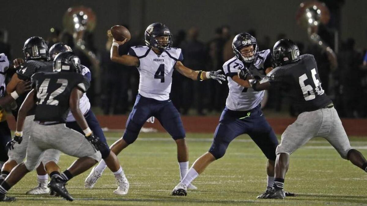 Arlington Heights quarterback Deontre Jones (4) looks for a receiver against the South Hills defense, Oct. 13, 2017.