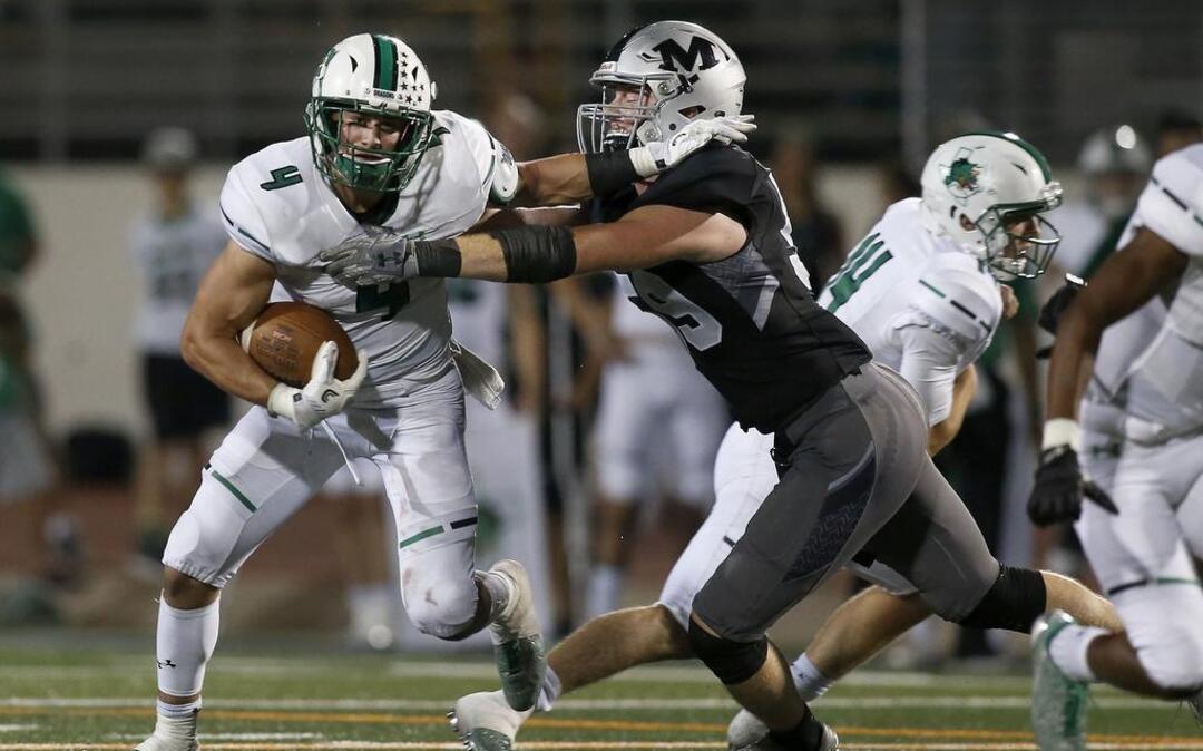 Southlake Carroll Dragons running back TJ McDaniel (4) is tackled short of the first down by Arlington Martin.