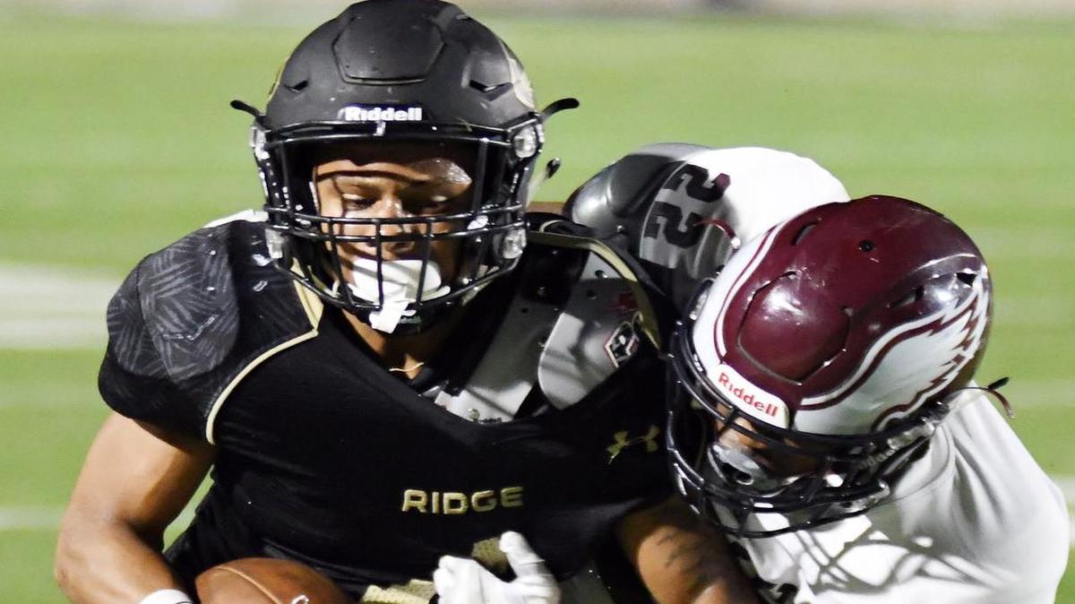 Fossil Ridge receiver Elijah Hicks, left, is brought down by Rowlett’s Jakel Davis, September 16, 2016.