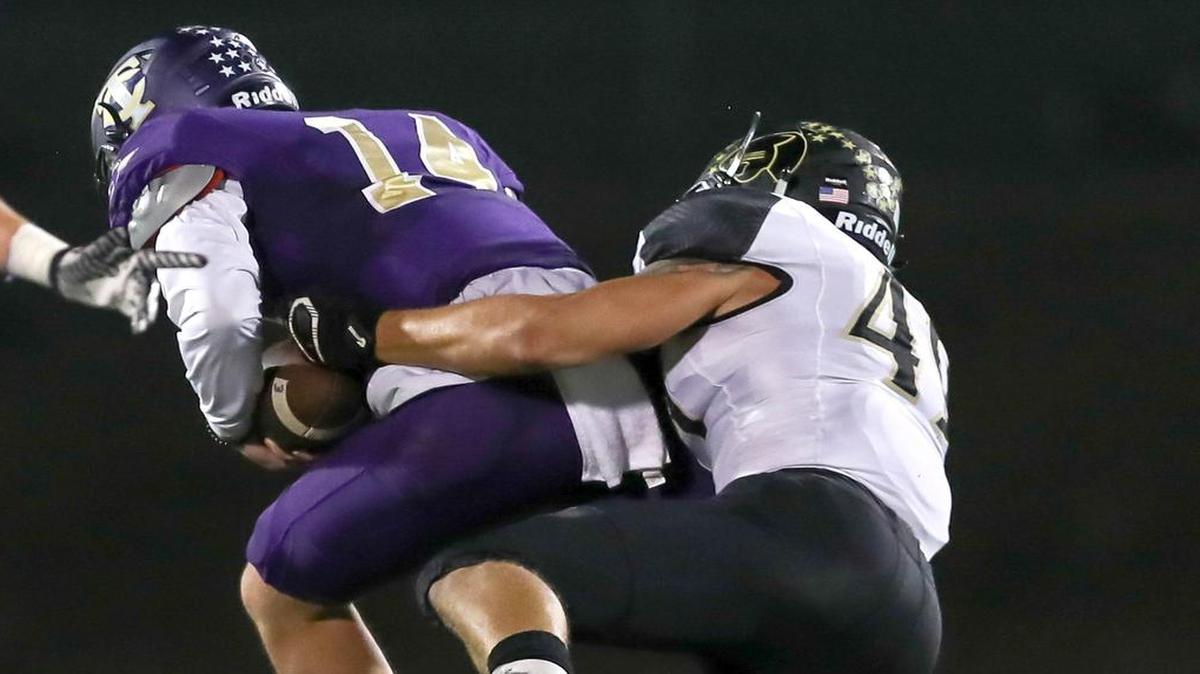 Keller Fossil Ridge linebacker Arnold Saidov, right, tackles Keller Timber Creek quarterback Adrian Ranete, Sept. 29, 2017.