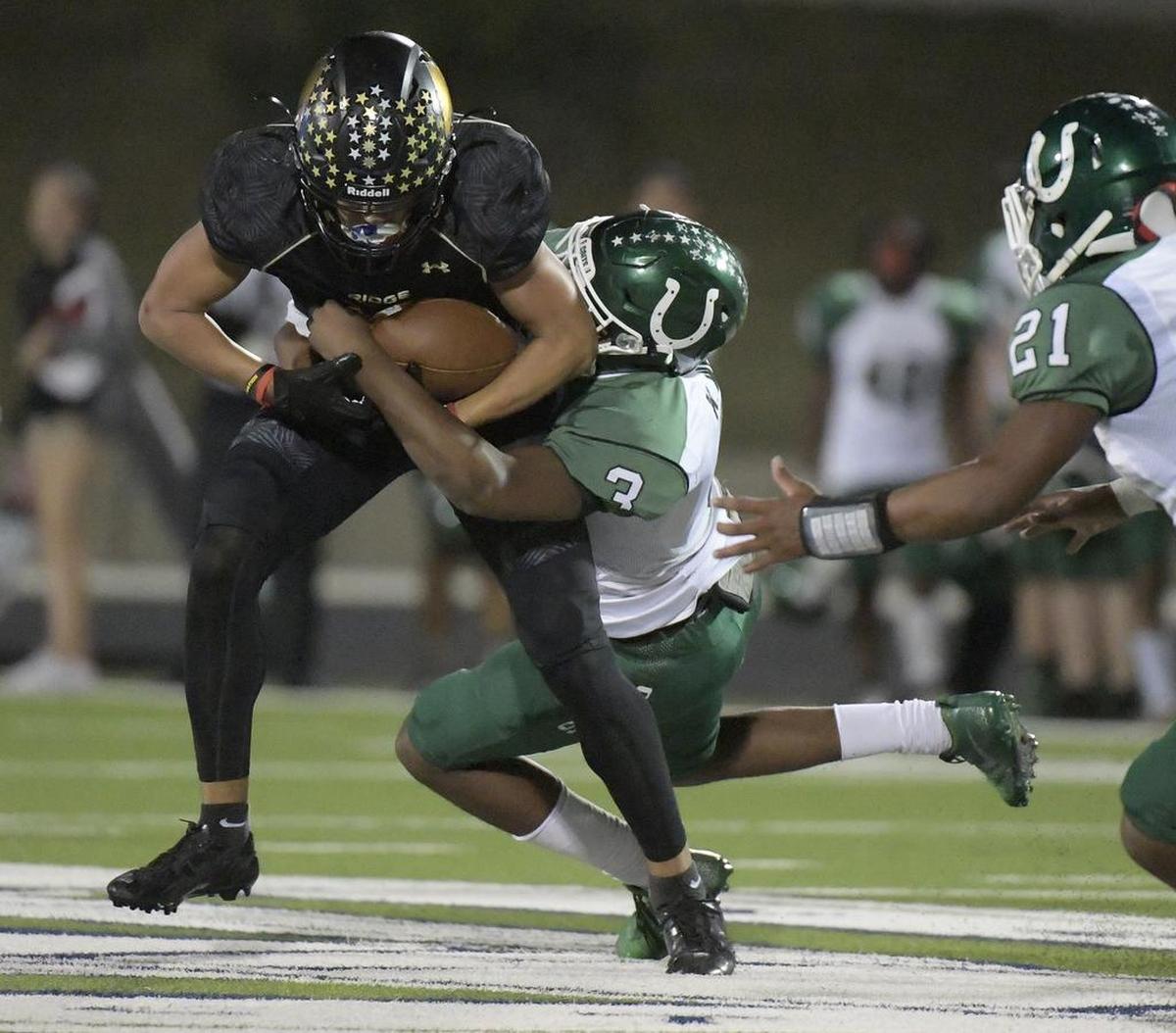 Fossil Ridge Panthers Jaylen Hearst (14) catches a pass for a big first down during the second quarter as Arlington Colts Kyron White (3) makes the stop.